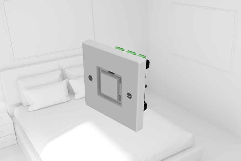 White square electrical switch plate with a recessed center switch in a bedroom setting on a bed's surface area.